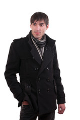 The man in the coat looks away