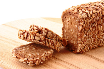 Bread on wooden plate isolated on white