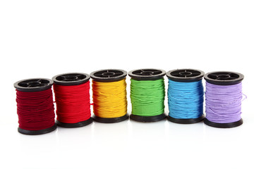 Coloured bobbins of thread isolated on white