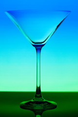 conceptually illuminated martini glass on gradient background