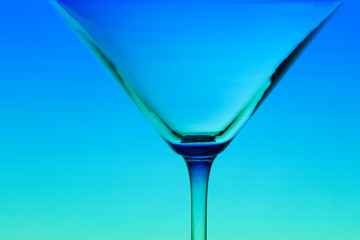 conceptually illuminated martini glass on gradient background