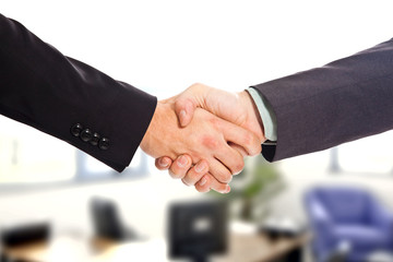 Businessman hands handshake with office background