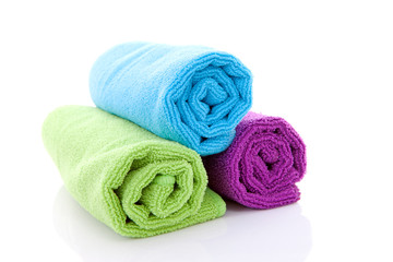 Fototapeta na wymiar colorful rolled towels over white background