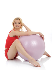 Fototapeta na wymiar Pretty fitness woman doing exercise with pilates ball. isolated