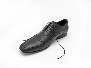 male black leather shoe against white