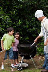 Family  having a barbecue in the garden