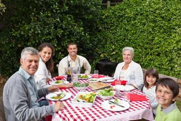 Happy family eating in the garden