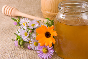 honey in glass pot on sacking