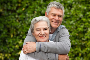 Mature couple hugging in the garden