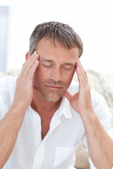 Fototapeta premium Man having a headache at home
