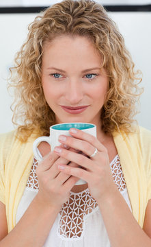 Pretty Woman Drinking Coffe In Her Kitchen At Home