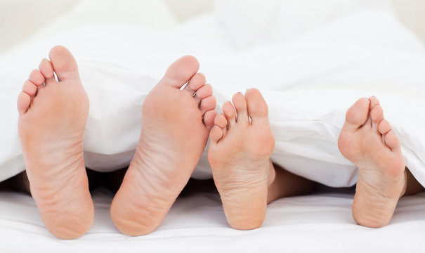 Family's feet in the bed