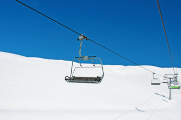 Ski lift chairs on bright winter day