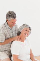 Retired man giving a massage to his wife