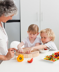 Children cooking with their grandmother at home
