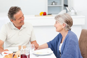 Retired couple eating  in the kitchen