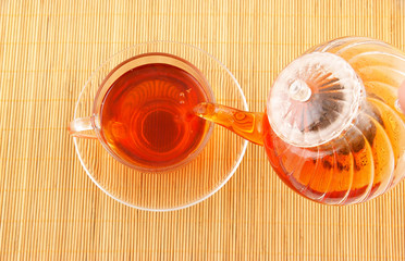 Tea pouring on wooden background