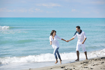 Fototapeta na wymiar happy young couple have fun at beautiful beach