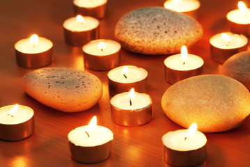 Burning candles and pebbles for aromatherapy session