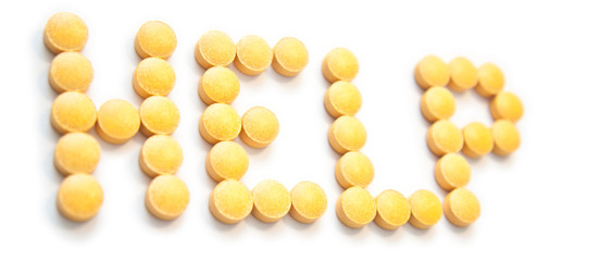 Help sign made out of orange pills