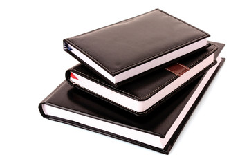 Three black notebooks on white background