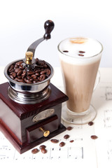 coffee grinder and coffee on sheet music