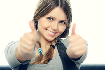 Portrait of attractive young female showing a thumbs up