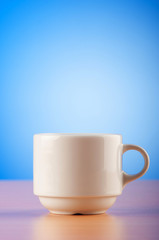White cup against colourful gradient on the table