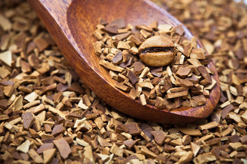 wood spoon of soluble coffee with coffee bean