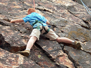 boy climbing on rope