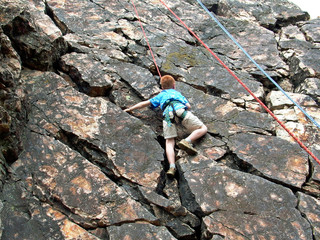 boy climbing on rope
