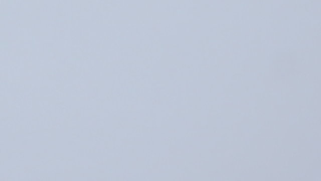 Snowboarder coming down on a snowboard