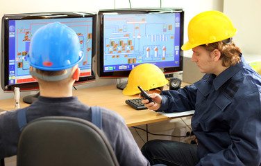 Two Workers in a Control room