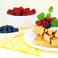 Tasty waffles and summery fruits.