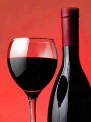 Red wine pouring down from a wine bottle