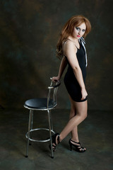 Fototapeta na wymiar Pretty female posing with bar stool