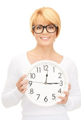 woman holding big clock