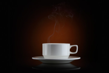 White mug of coffee against a dark background
