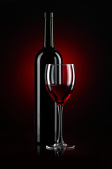 bottle with red wine and glass