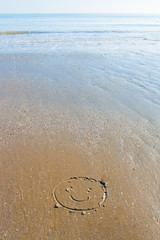Fototapeta na wymiar A Smiling Face written in the sand