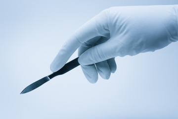 surgeon hand with scalpel during surgery