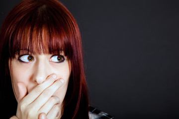 Scared girl in a dark background