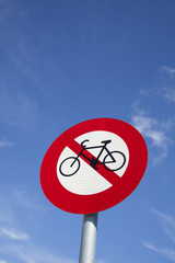 No bicycle sign with blue sky background.