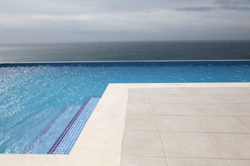 Modern swimming-pool with view towards the ocean