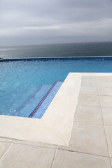 Modern swimming-pool with view towards the ocean