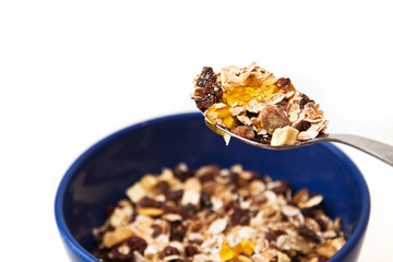 Bowl of muesli with honey on white background