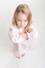 Aerial view of a furious blonde kid in her pajamas