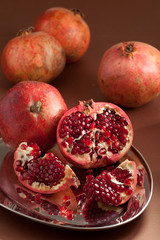 Pomegranate slices and seeds on silver tray