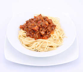 Spaghetti bolognese on a plate on a white background