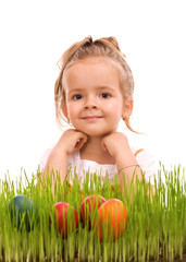 Fototapeta na wymiar Happy easter girl with colorful eggs in fresh grass
